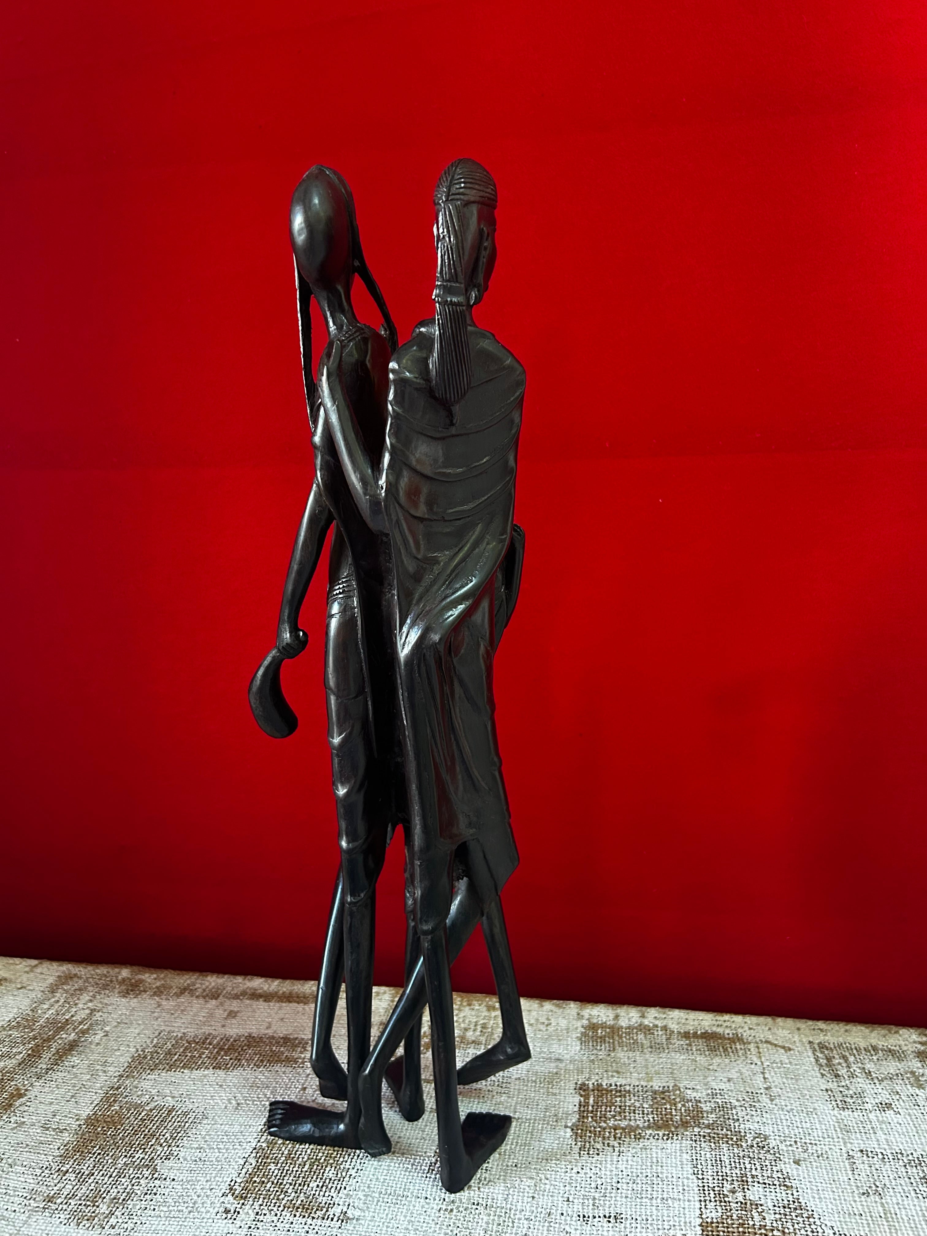 African art sculpture at Rogl Souvenirs & Gallery against red background.