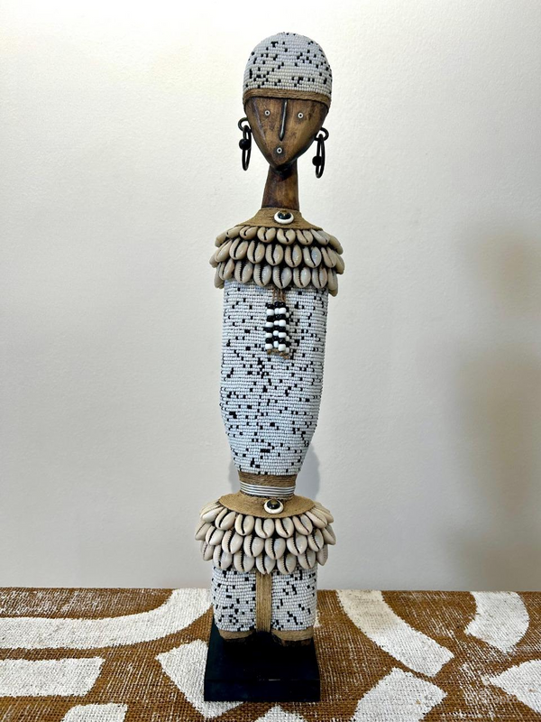 Beaded Namji doll in black and white with intricate patterns, displayed at Rogl Souvenirs & Gallery, African art collection.