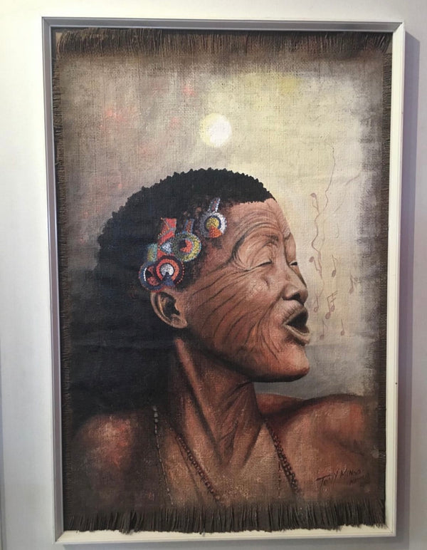 Bushman Melodies painting by Tony, featuring a bushman woman singing, adorned with colorful jewelry, in earthy tones, capturing Namibian landscape and cultural richness, displayed in a modern frame.