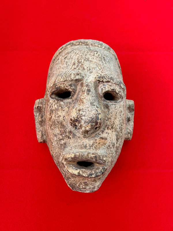 Handcrafted Mbona tribe day mask from Congo-Zaire, showcasing sandy brown patina on heavy wood, symbolizing abundance and vitality.
