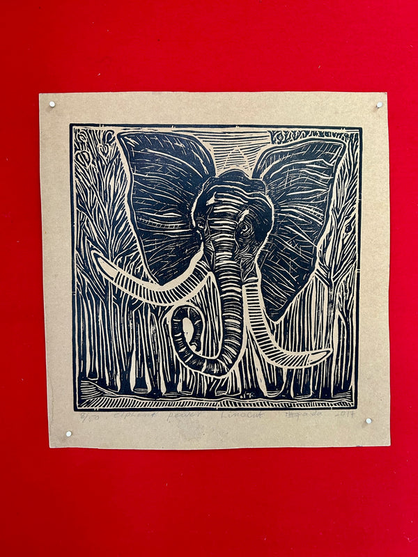 Linocut print of an elephant by artist Kapanda, featuring black and brown colors on a red background, showcasing the animal's grace and strength, available at Rogl Souvenirs & Gallery, African art gallery.