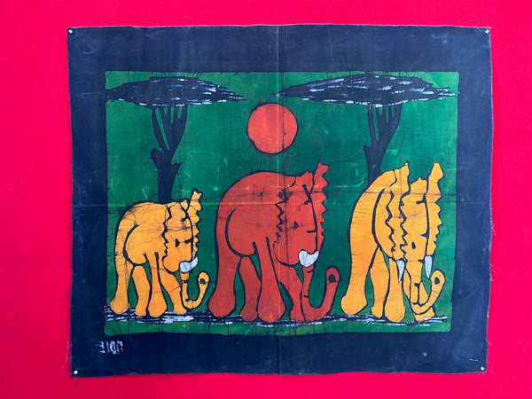 Elephant trio wax batik art from Mozambique, featuring vibrant multi-color design on fabric, landscape orientation.