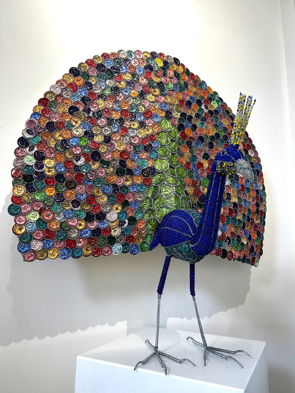 Espresso Feathered Peacock sculpture made from repurposed coffee capsules, beads, and metals, showcasing vibrant multi-color plumage, displayed at Rogl Souvenirs & Gallery, African art gallery.