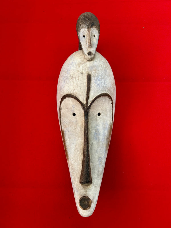 Ceremonial Fang mask from Gabon with superimposed face, white chalk finish, African art at Rogl Souvenirs & Gallery.