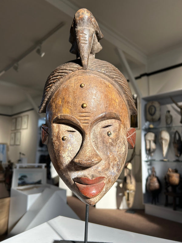 Idoma ceremonial mask with bird symbol, used in dance ceremonies, showcasing traditional face markings and cultural artistry from Niger.