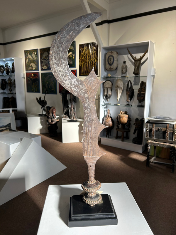 Rare tribal sword from the Kuba-Bakuba tribe of Congo-Zaire, showcasing intricate craftsmanship and cultural significance, displayed in an art gallery setting.