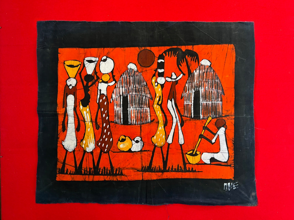 Wax batik art from Mozambique depicting rural life with vibrant colors and intricate designs on fabric, displayed in landscape orientation.