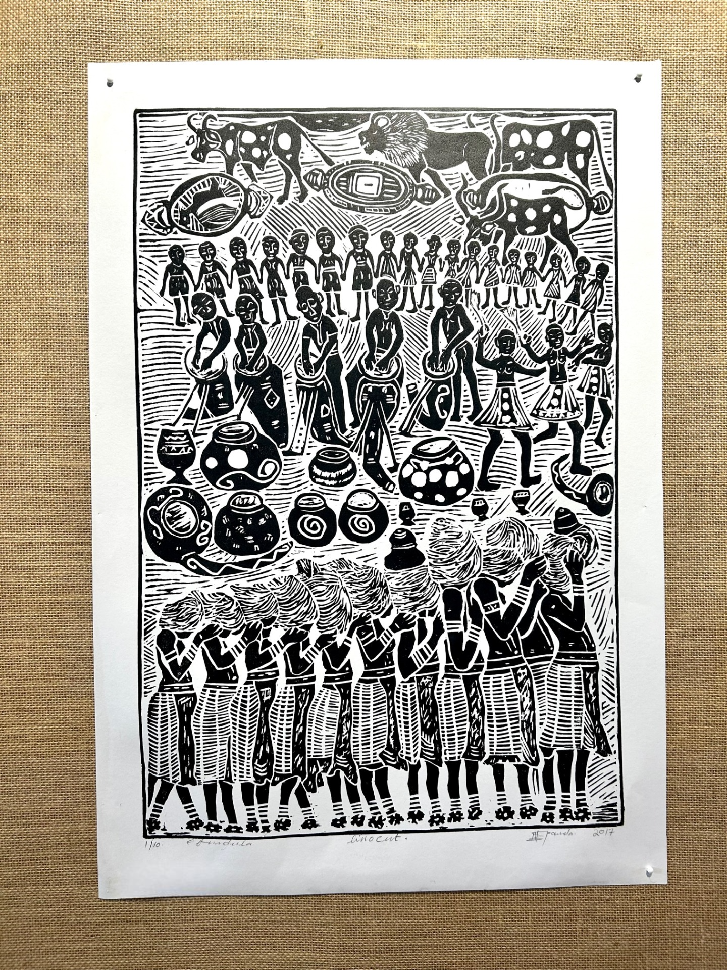 Black and white linocut print depicting a vibrant tribal celebration in northern Namibia, featuring traditional dancers, music, and instruments, showcasing intricate details and cultural heritage.