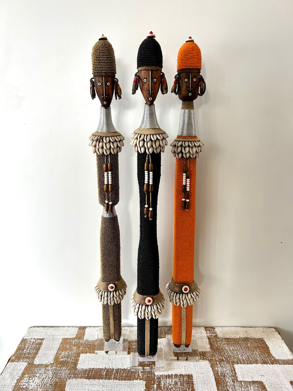 Multi-colour beaded Namji doll set from Cameroon, featuring three unique fertility dolls adorned with beads and cowrie shells, representing the Namji tribe's traditional craftsmanship.