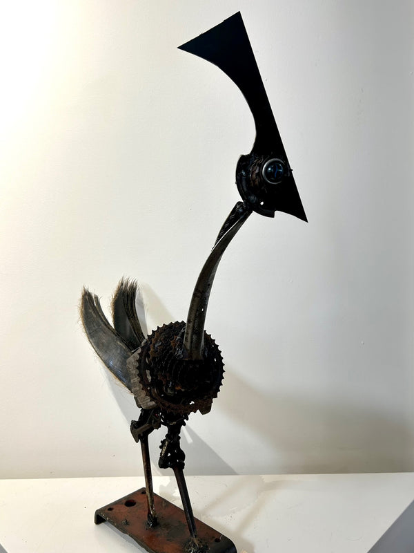Roadrunner sculpture made from scrap metals and dried palm leaves, showcasing intricate craftsmanship and dynamic design, available at Rogl Souvenirs & Gallery.