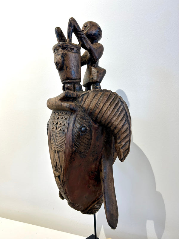 Senufo antelope mask from Ivory Coast featuring abstract design with antelope horns and tusks, symbolizing strength and power, displayed at Rogl Souvenirs & Gallery.