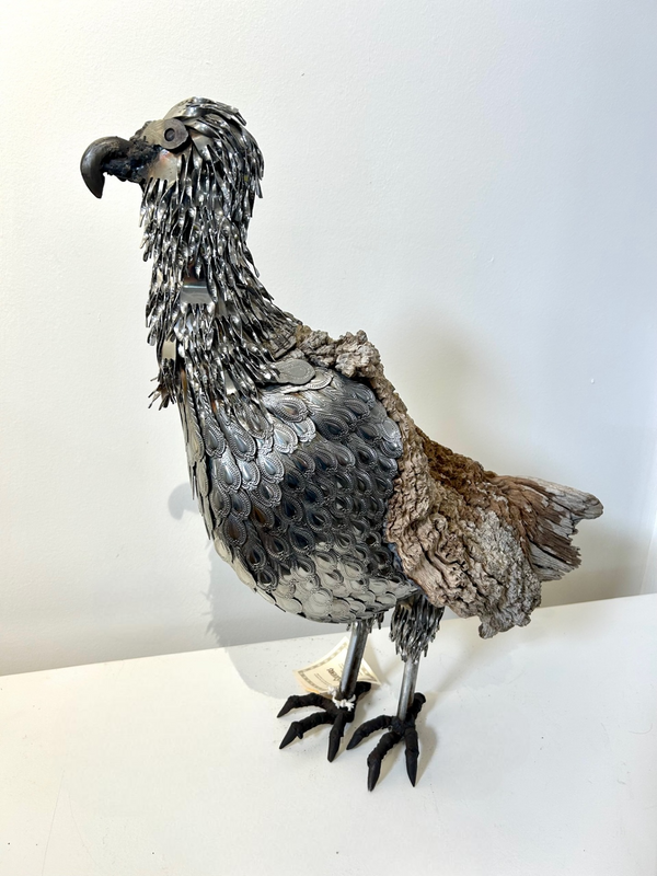 Silver eagle sculpture crafted from silver cutlery and camel thorn wood, showcasing intricate details and natural textures, available at Rogl Souvenirs & Gallery.